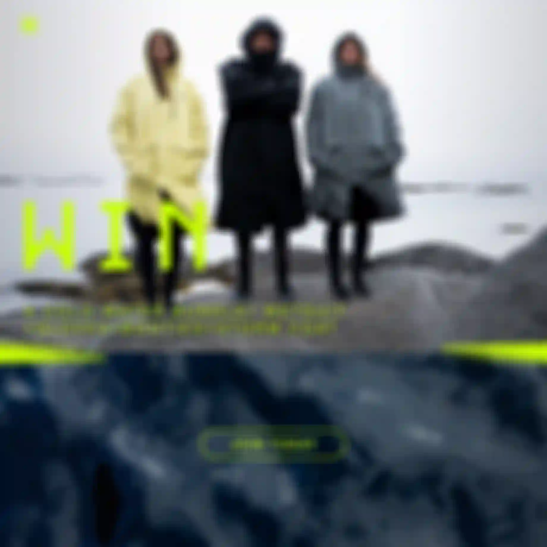 Three riders in hooded storm coats standing on coastal rocks in cold weather, promoting a cold-water gear bundle giveaway.