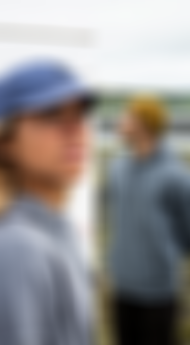 Side-by-side images: A woman in a blue cap looking up, and a man in a yellow beanie looking to the side, both in outdoor settings.