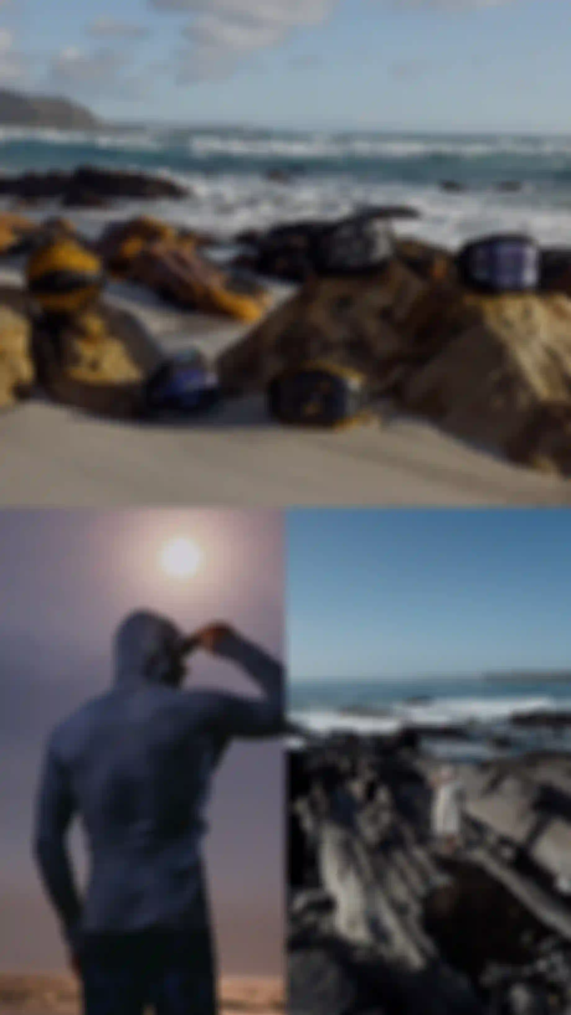 A beach scene with harnesses on rocks, a person in a hooded rashguard sheltering their eyes against the sun, and another person walking on rocky terrain by the sea.