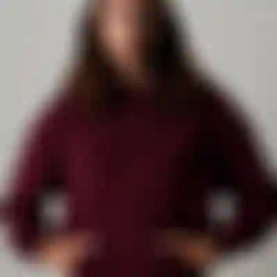 Woman wearing a dark red hoodie with ION logo and a light yellow fisherman beanie