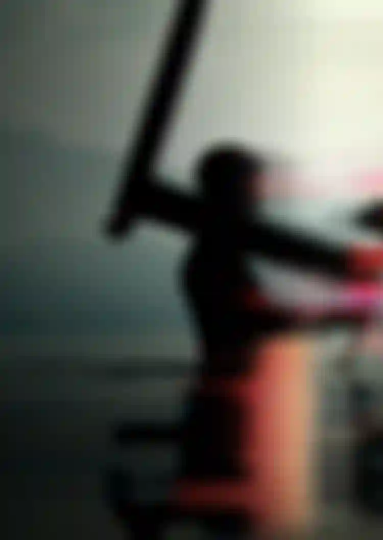 Abstract image of a person standing in water, holding a foil board, with a distorted, colorful background of mountains and sky.