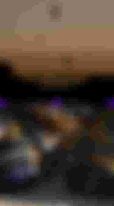 Kite flying at sunset; rocks in foreground. Footwear on a sandy beach with "Spring/Summer 2026" text in the center.