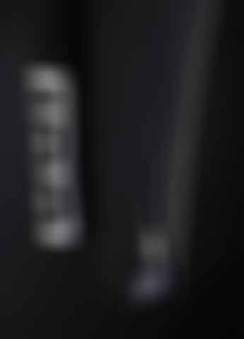 close up of black kids rental wetsuit with zipper at the end of the legs