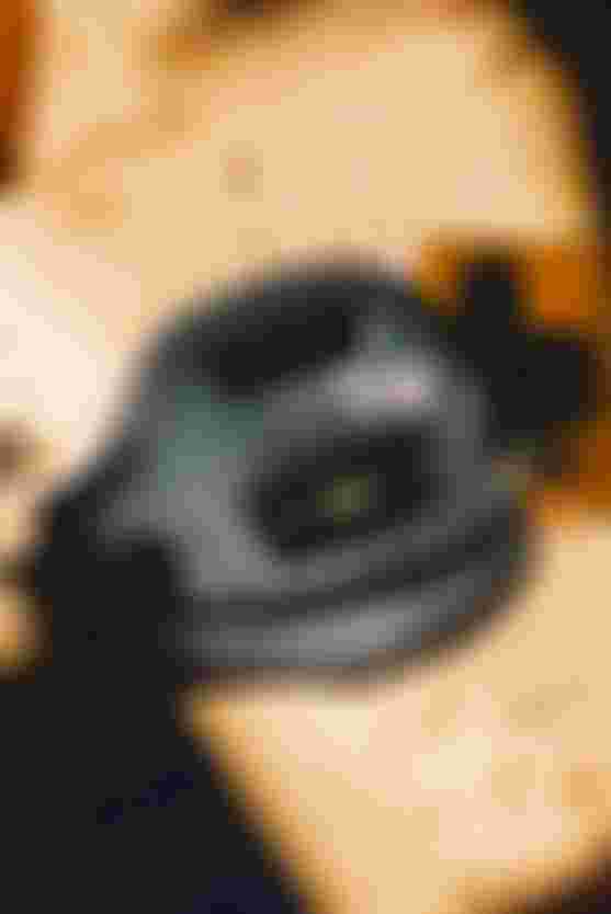 Dark blue kite harness with wording "nova" on sand with shadows around