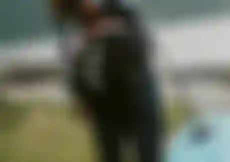 Woman carrying a foil board on her shoulder