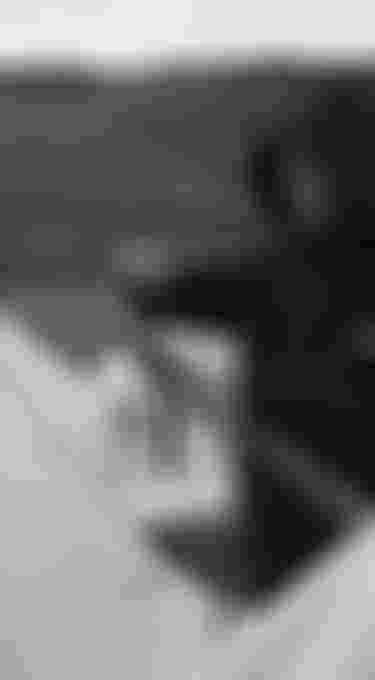 Edgar Ulrich setting up a kite wearing a neoprene hoodie