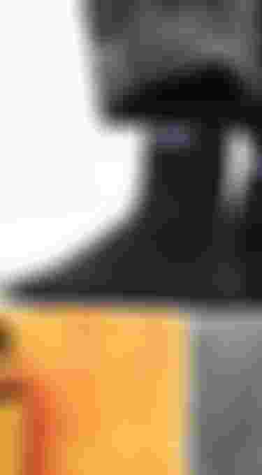 Close up of two feet wearing black socks with white ION print on top