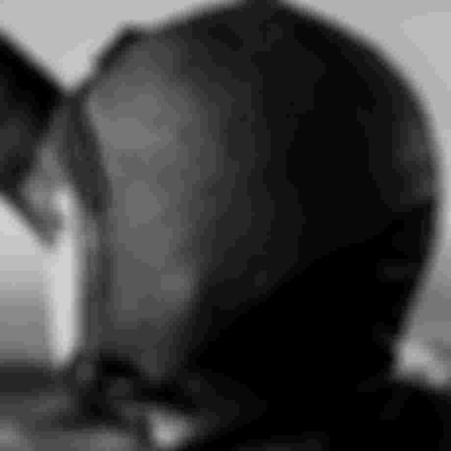 Close up from behind of a person's head wearing a neoprene hood, black and white image