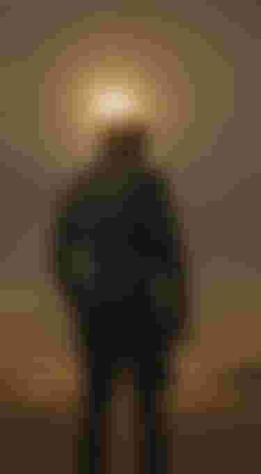 Silhouette of a person against the sun with ocean in the background