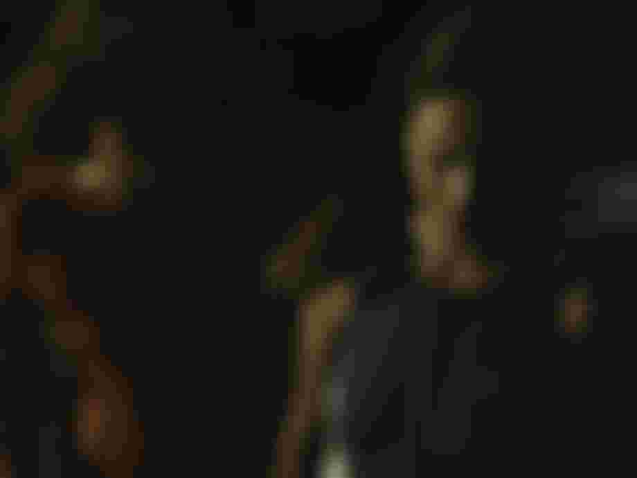 Two women in summer wetsuits on a beach