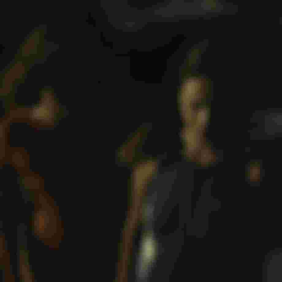 Two women in summer wetsuits on a beach