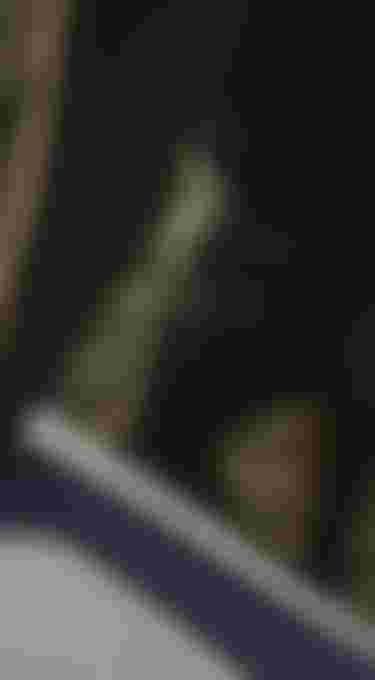 Close up view of a olive green men's boardshort worn by Noe Font