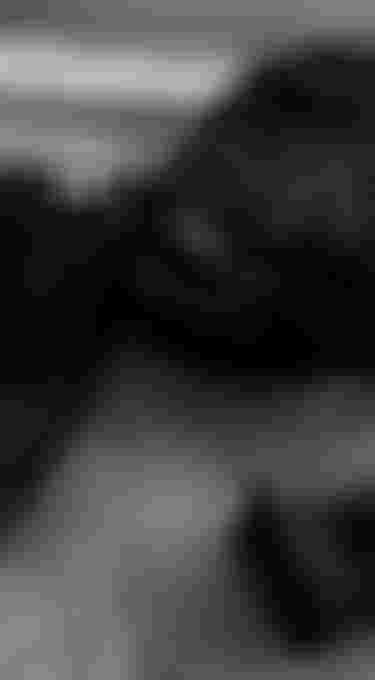 Disassembled pump foil and boardbag lying on the pavement