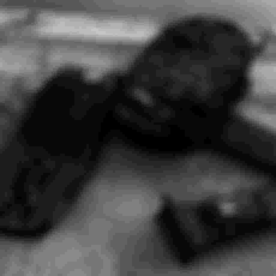 Disassembled pump foil and boardbag lying on the pavement