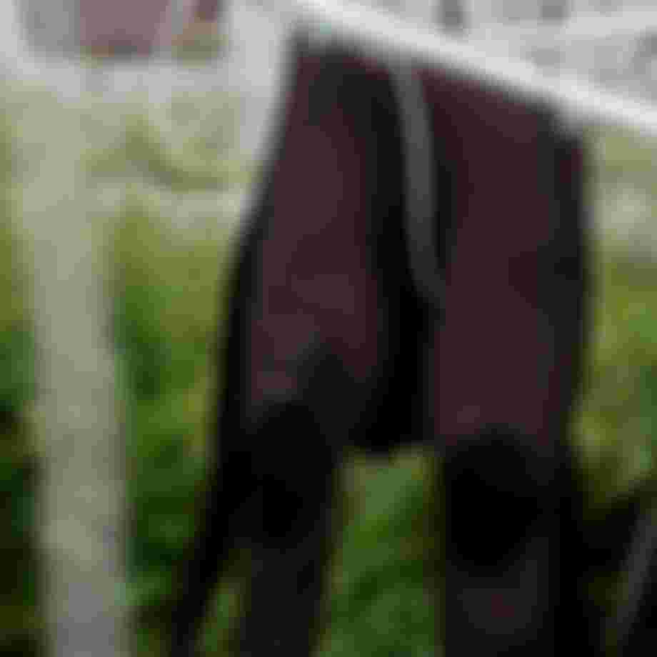 Brown wetsuit hanging on a clothing line