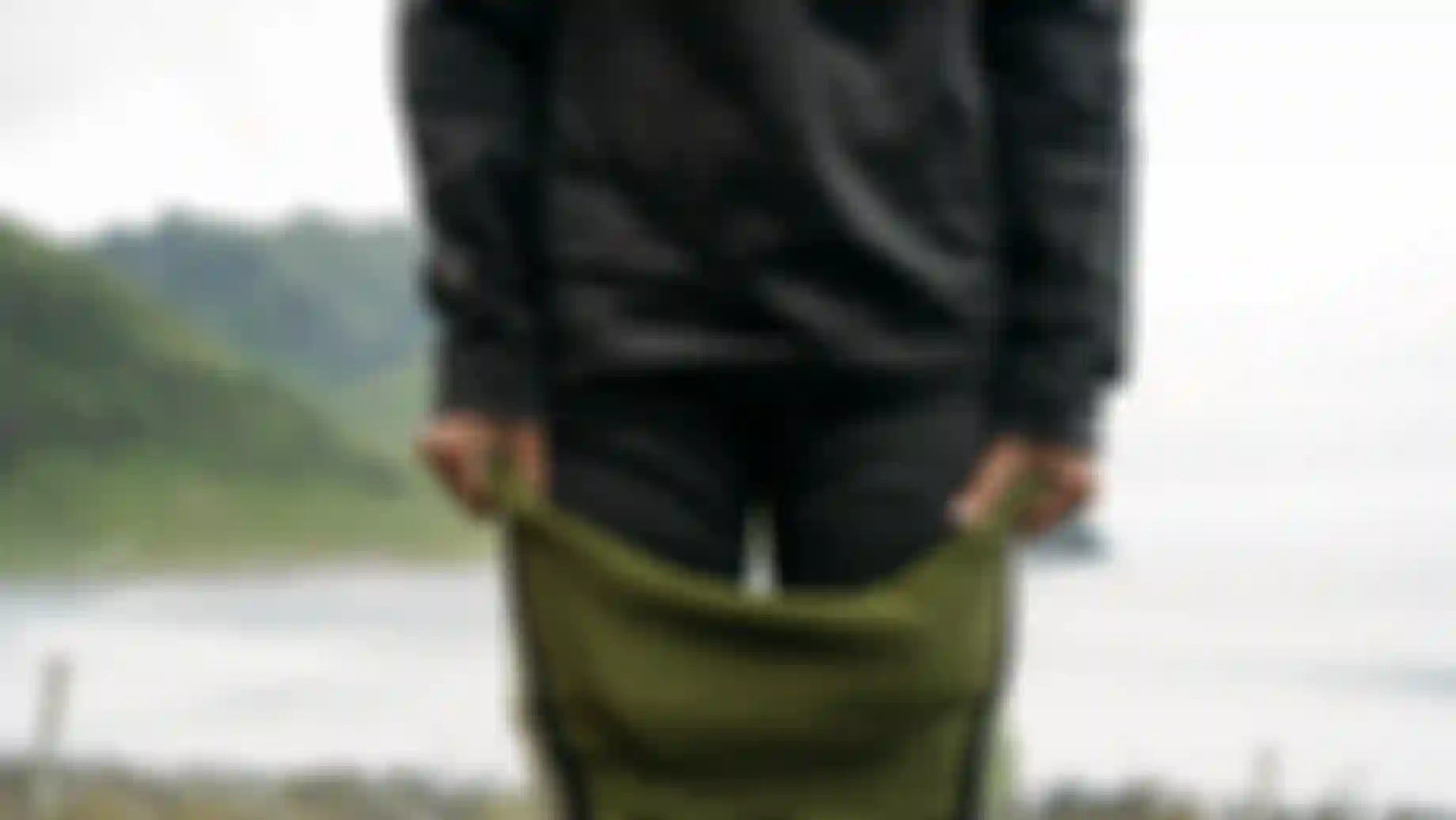 Person pulling on a wetsuit