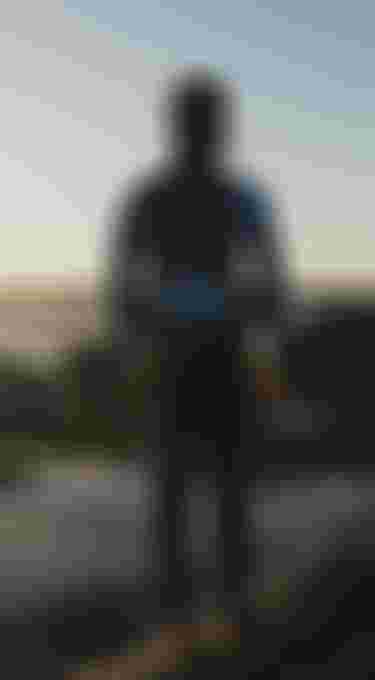 kid in a blue wetsuit with hood