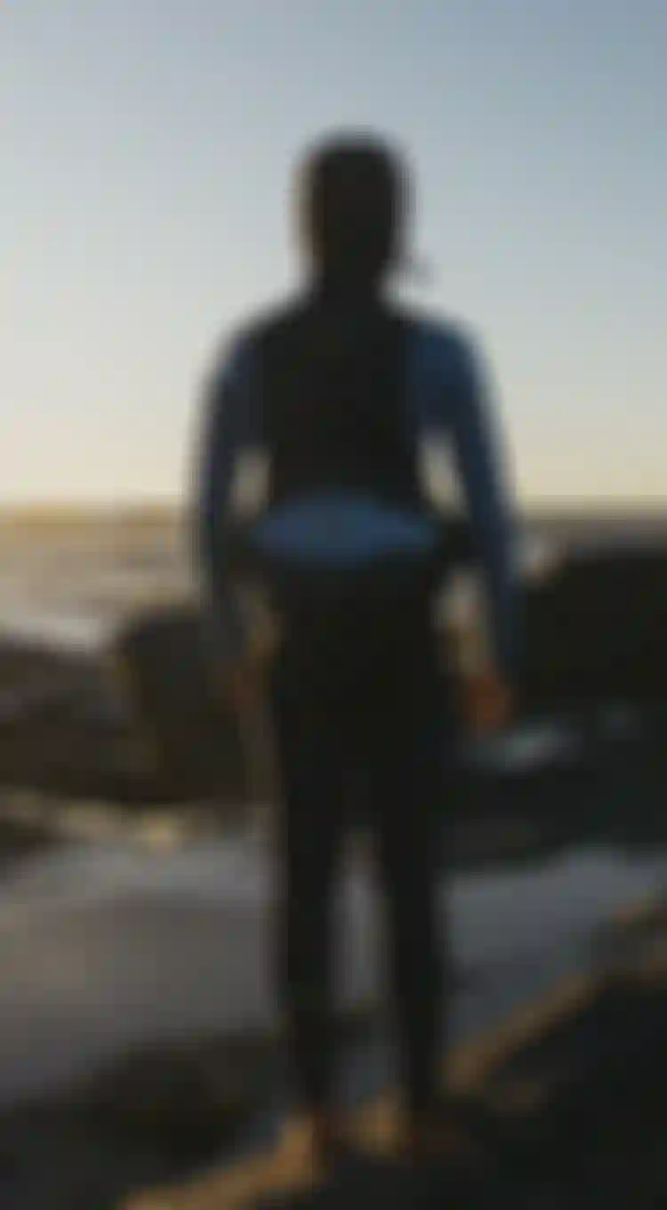kid in a blue wetsuit with hood