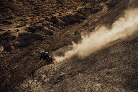 ION Bike S-Pad Amp shin pads during mountain biking on a dusty mountain trail