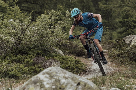 ION Bike Traze cycling socks during mountain biking on a rocky forest trail