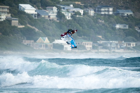 ION Water Foot Protector during wave riding on the ocean with windsurfer airborne