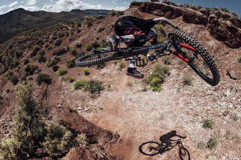 ION Bike Scrub Select flat pedal shoes in dark brown during mountain biking on red rock terrain