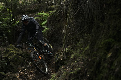 ION Bike K-Traze Amp veste de protection en noir lors du vélo de montagne en forêt