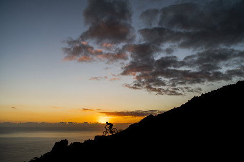 ION Bike Protection Short Scrub AMP impact shorts during mountain biking on a coastal ridge at golden hour