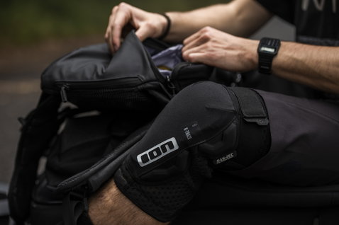 ION Scrub 14 backpack in black during mountain biking on the trail
