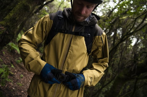 ION Scrub 14 backpack in olive and black worn during mountain biking in forest
