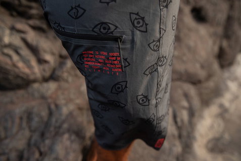 ION Slade boardshorts in dark charcoal with all-over eye print, pocket detail view