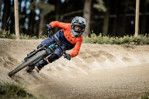 Genouillères ION K-Pact jeunes en noir lors d'une session de VTT en bike park
