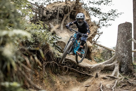 ION Scrub youth bike gloves during mountain biking on a technical forest trail