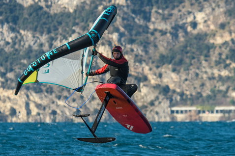 ION Fuse Drysuit 4/3mm back-zip fullsuit in dark navy and teal during wing foiling