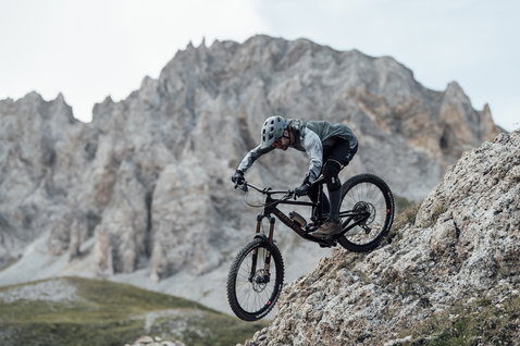 Joelheiras ION K-Lite Zip durante mountain bike enduro em terreno alpino rochoso