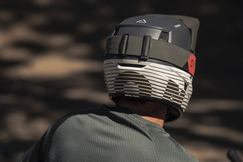 ION Scrub Amp fullface helmet in charcoal and light grey during mountain biking on trail