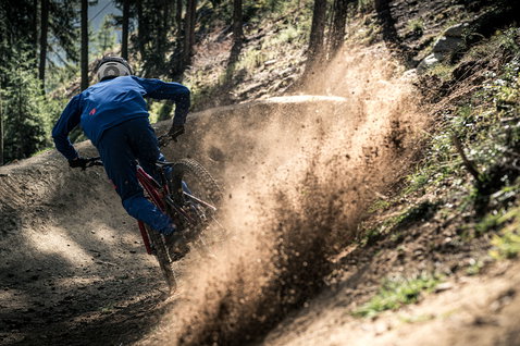 ION Scrub cycling pants in cobalt blue during downhill mountain biking on a forest trail