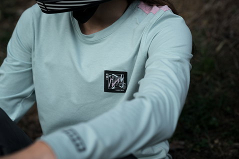 ION Seek Amp LS women's cycling jersey in mint during mountain biking in the forest
