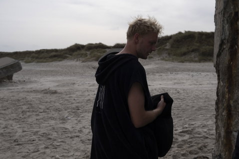 ION Core unisex surf poncho during beach change in black