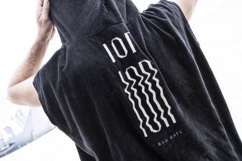 ION Core surf poncho unisex in black with ION wave graphic print on the back