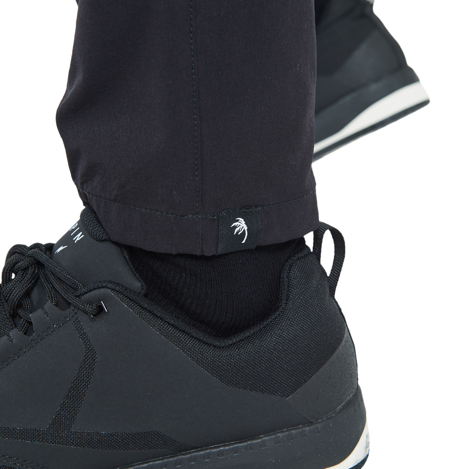 ION Bike Scrub unisex cycling pants in black, ankle logo detail for downhill and enduro mountain biking