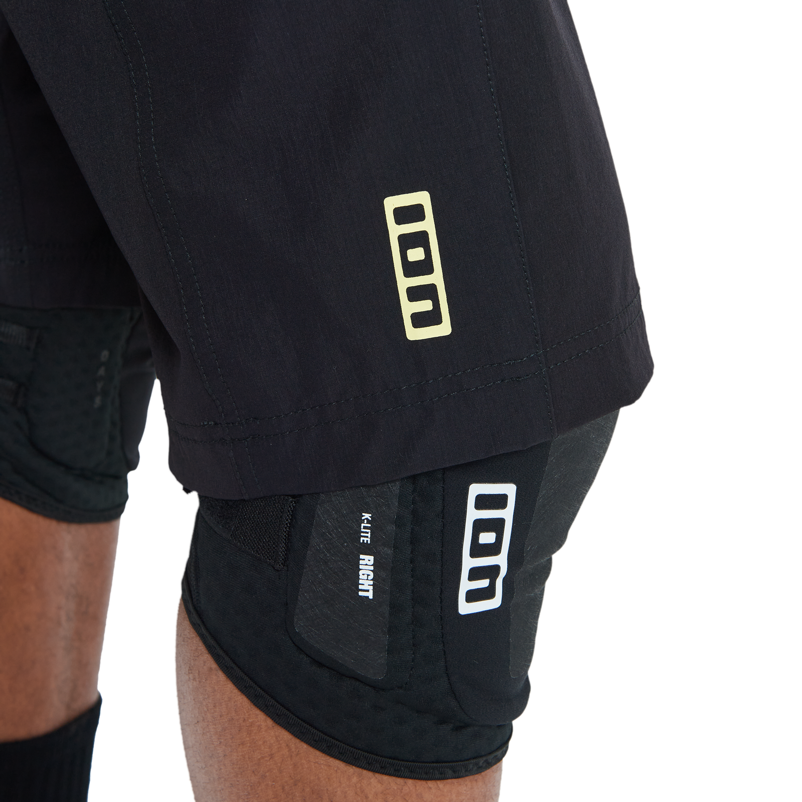 ION Bike Scrub men's cycling shorts in black with K-LITE knee pads, detail view for enduro mountain biking