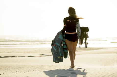 ION Vega soft seat harness during kitesurfing beach walk on sunny ocean beach