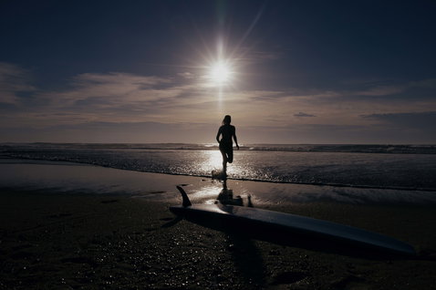 ION Element 3/2mm front-zip fullsuit wetsuit during wave riding on the beach at golden hour