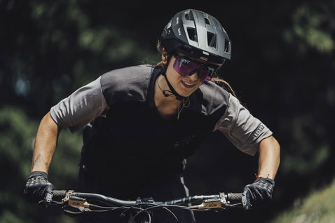 ION Scrub Amp SS women cycling jersey in charcoal black during mountain biking in forest
