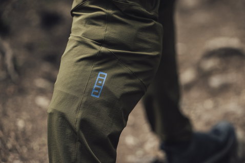 ION Scrub cycling pants in olive green during mountain biking on the trail