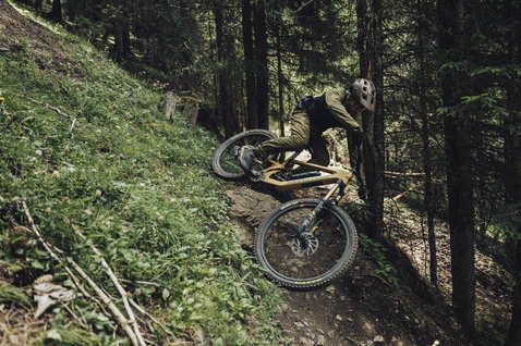 ION Bike Scrub men cycling pants in olive green during freeride mountain biking in forest