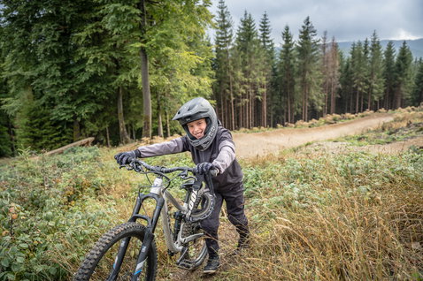ION Scrub Youth full-finger bike gloves in dark olive during mountain biking in forest trail