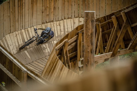 ION Bike Scrub Amp fullface helmet during mountain biking on a wooden wall feature at a bike park