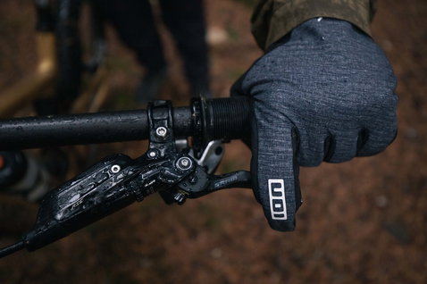 ION Shelter Amp Hybrid Padded full-finger bike gloves in charcoal grey during mountain biking in forest